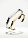 Silver and gold bangles on a white background