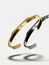 Gold and silver bangles on a light gray background