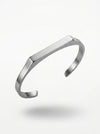Silver bracelet on a light gray background
