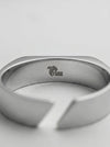 Silver ring with a brand logo on a light gray background