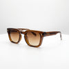 Brown sunglasses with a tortoiseshell frame on a white background