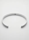 Silver bangle on a light gray background