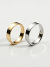 Gold and silver rings on a light gray background