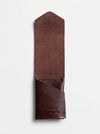Brown leather wallet on a light gray background