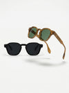 Two pairs of sunglasses, one black and one brown with green lenses, on a white background.
