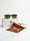 Sunglasses with a decorative box and tiger print fabric on a white background