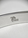 Close-up of a white product with 'Tucc' branding on a light gray background