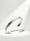 Silver bracelet on a light gray background
