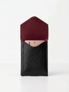 Black leather phone case with a red interior on a white background
