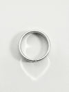 Silver ring on a light gray background